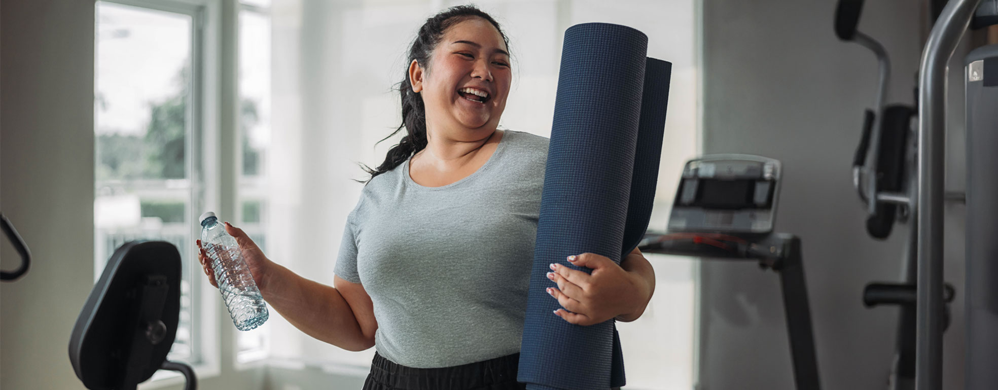 Woman managing diabetes in the workplace, wrapping up yoga mat